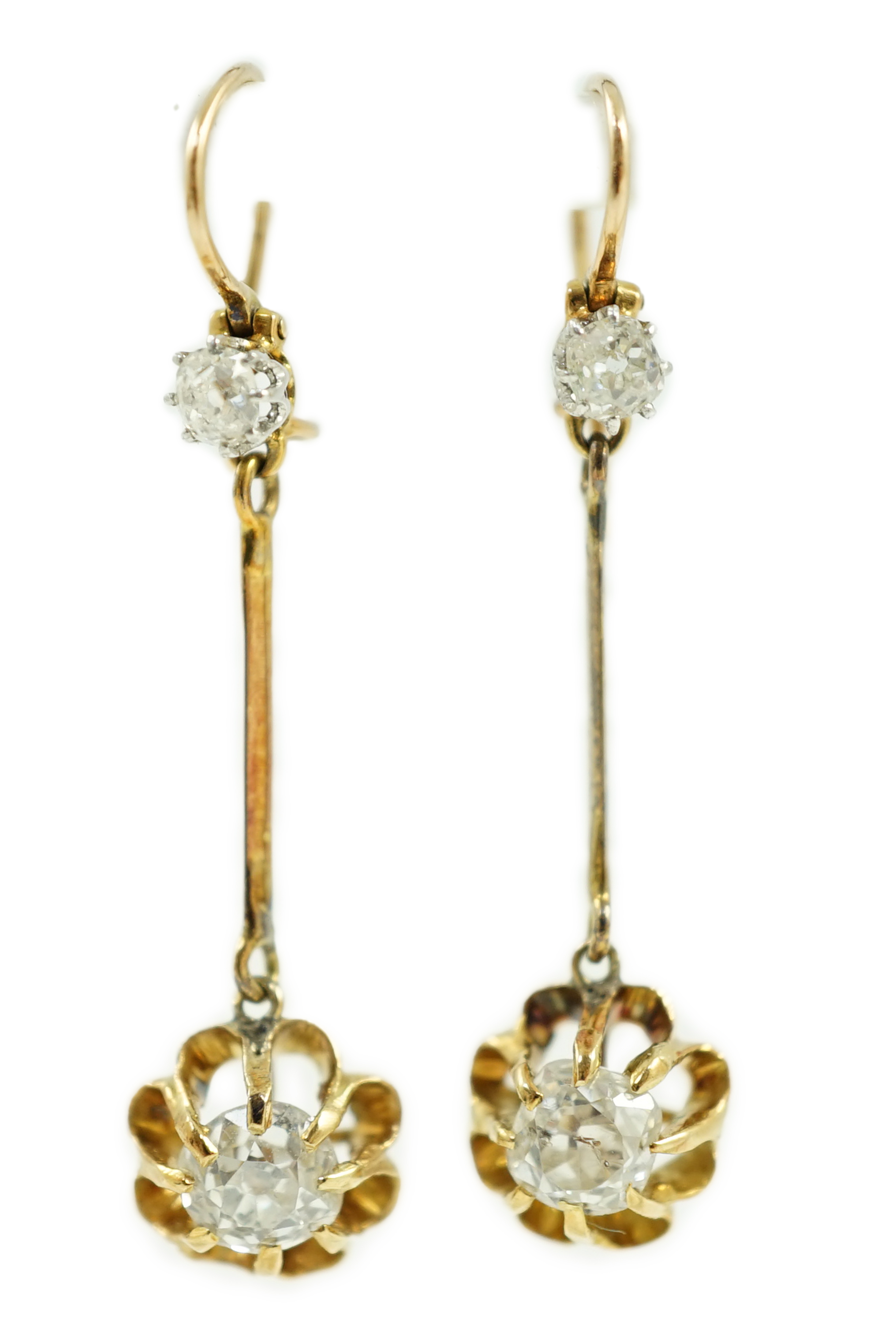 A pair of late 19th/early 20th century gold and four stone diamond set drop earrings